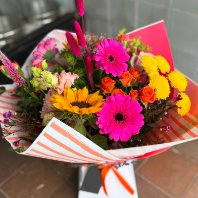 Tropical Sunset Bouquet - A vibrant hand-tied bouquet bursting with bold pink, orange and golden tones, designed to bring joy to any occasion.